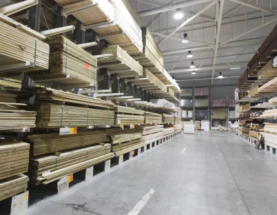 A large aisle of wood from a trade merchants store